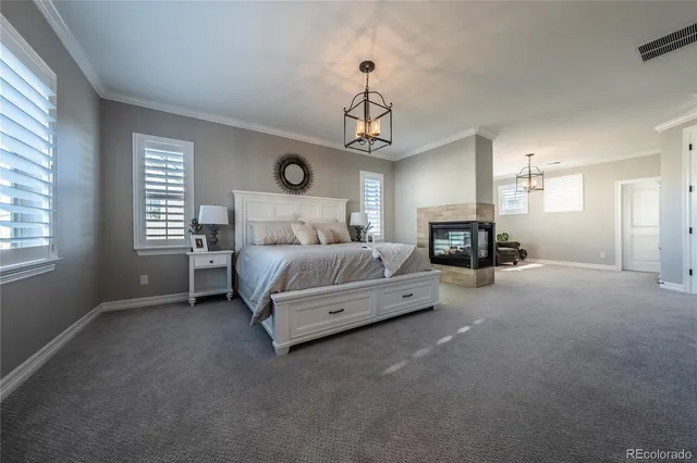 a spacious bedroom with a bed couch and window