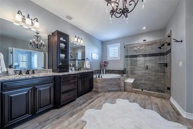a large bathroom with a sink a large mirror and a shower