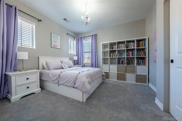 a spacious bedroom with bed and a large window