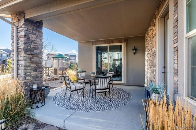 a view of a patio with table and chairs and potted plants