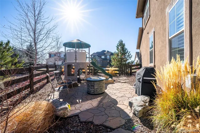 a view of a house with backyard and sitting area