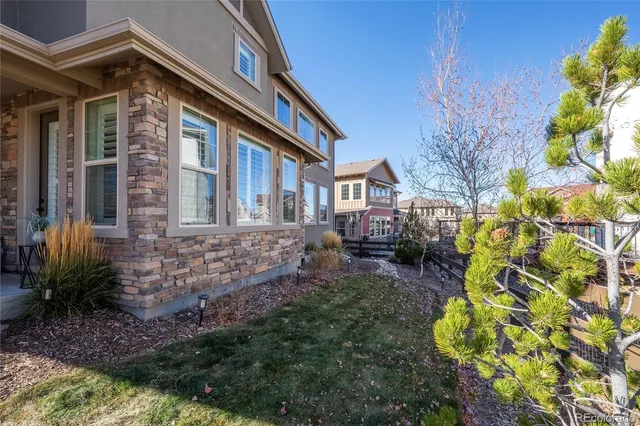 an aerial view of a house with a yard and lake view