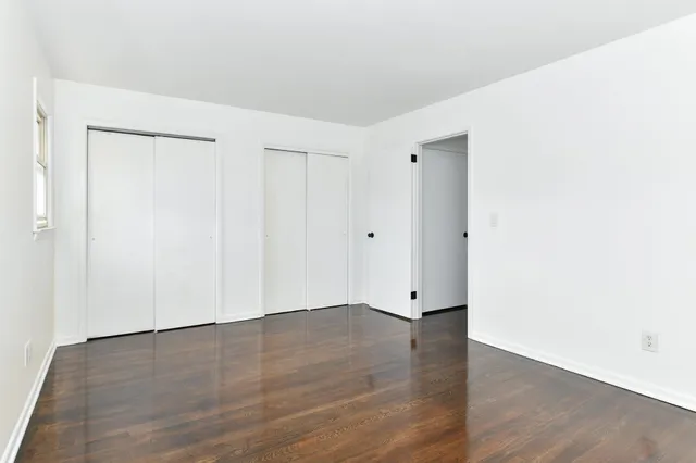 an empty room with wooden floor