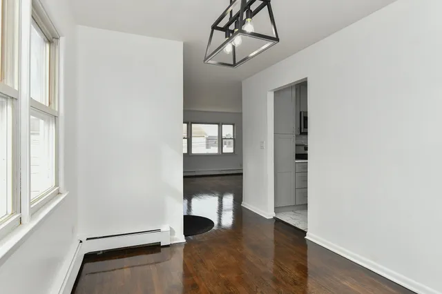 a view of an entryway with wooden floor and a window