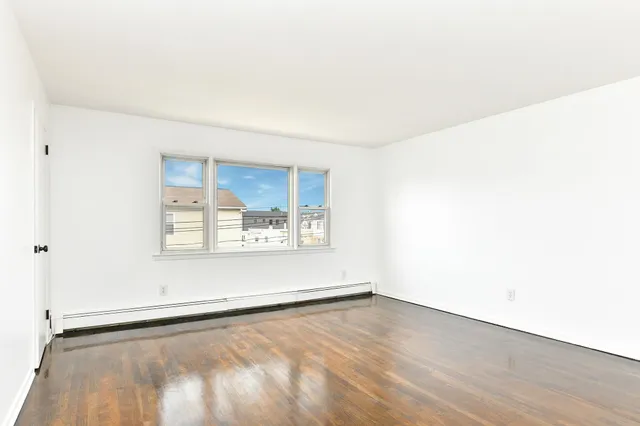 a view of an empty room and a window