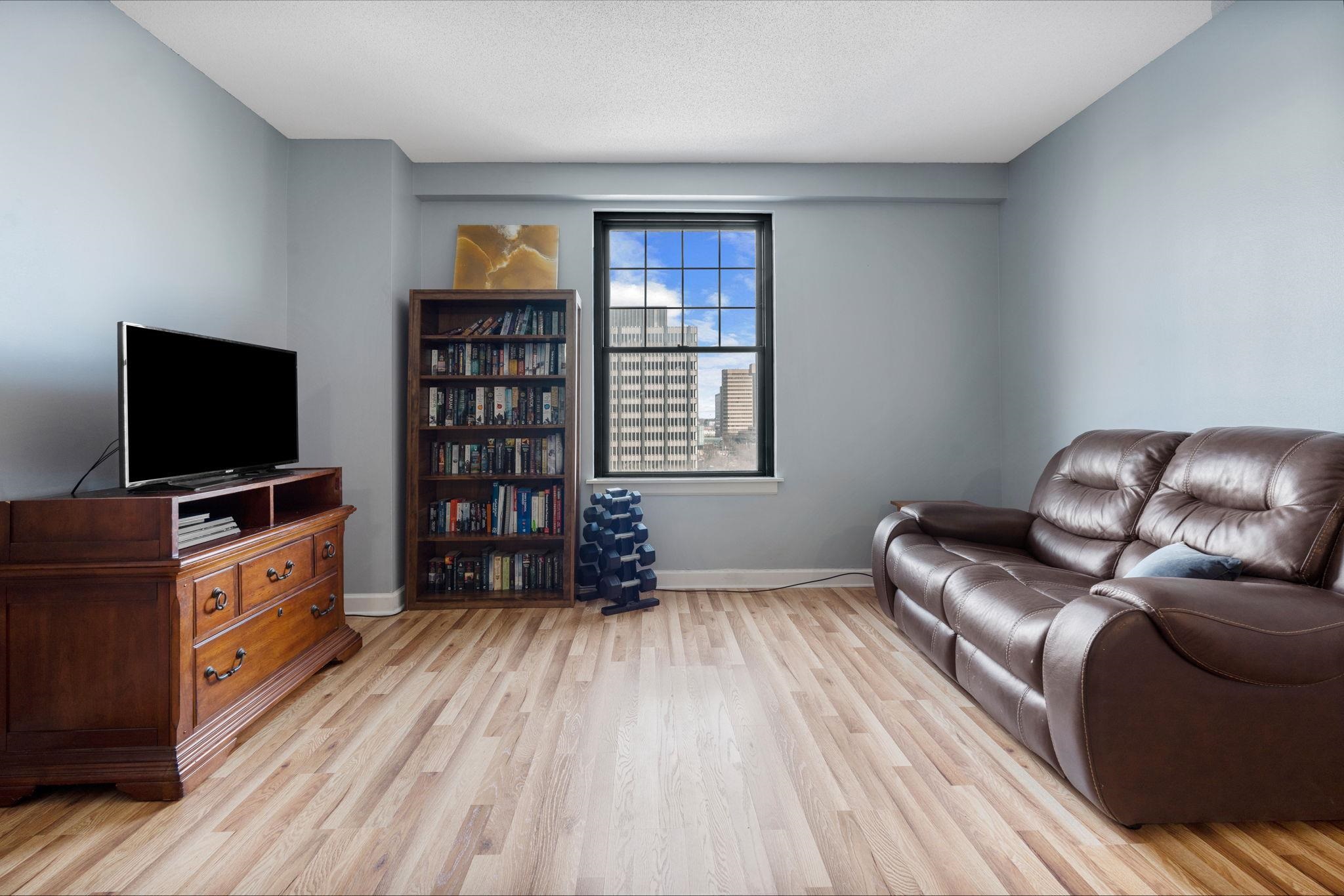 109 North Main Street, Unit 710 Memphis, TN 38103 - Photo 12 of 37 a living room with furniture and a flat screen tv