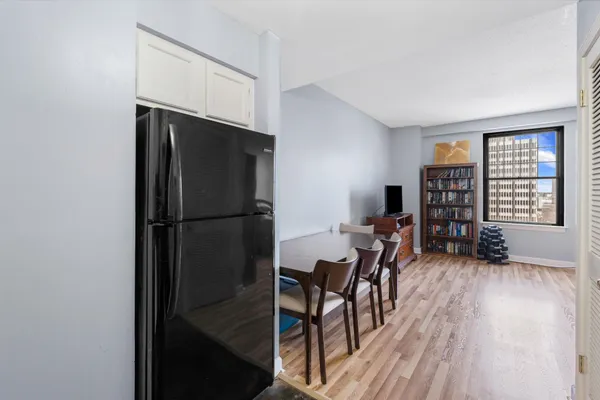 a dining room with furniture and wooden floor