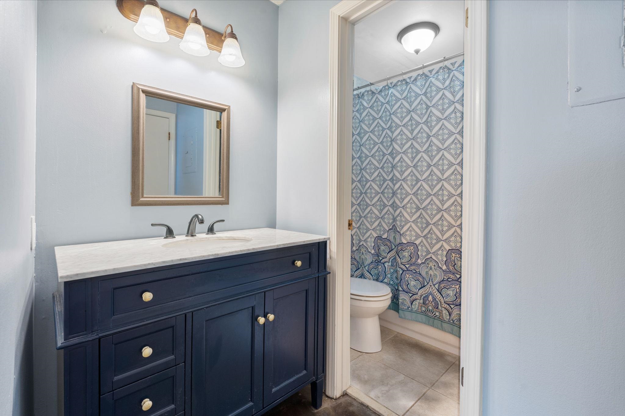 109 North Main Street, Unit 710 Memphis, TN 38103 - Photo 19 of 37 Full bathroom featuring vanity, curtained shower, and dark tile patterned flooring