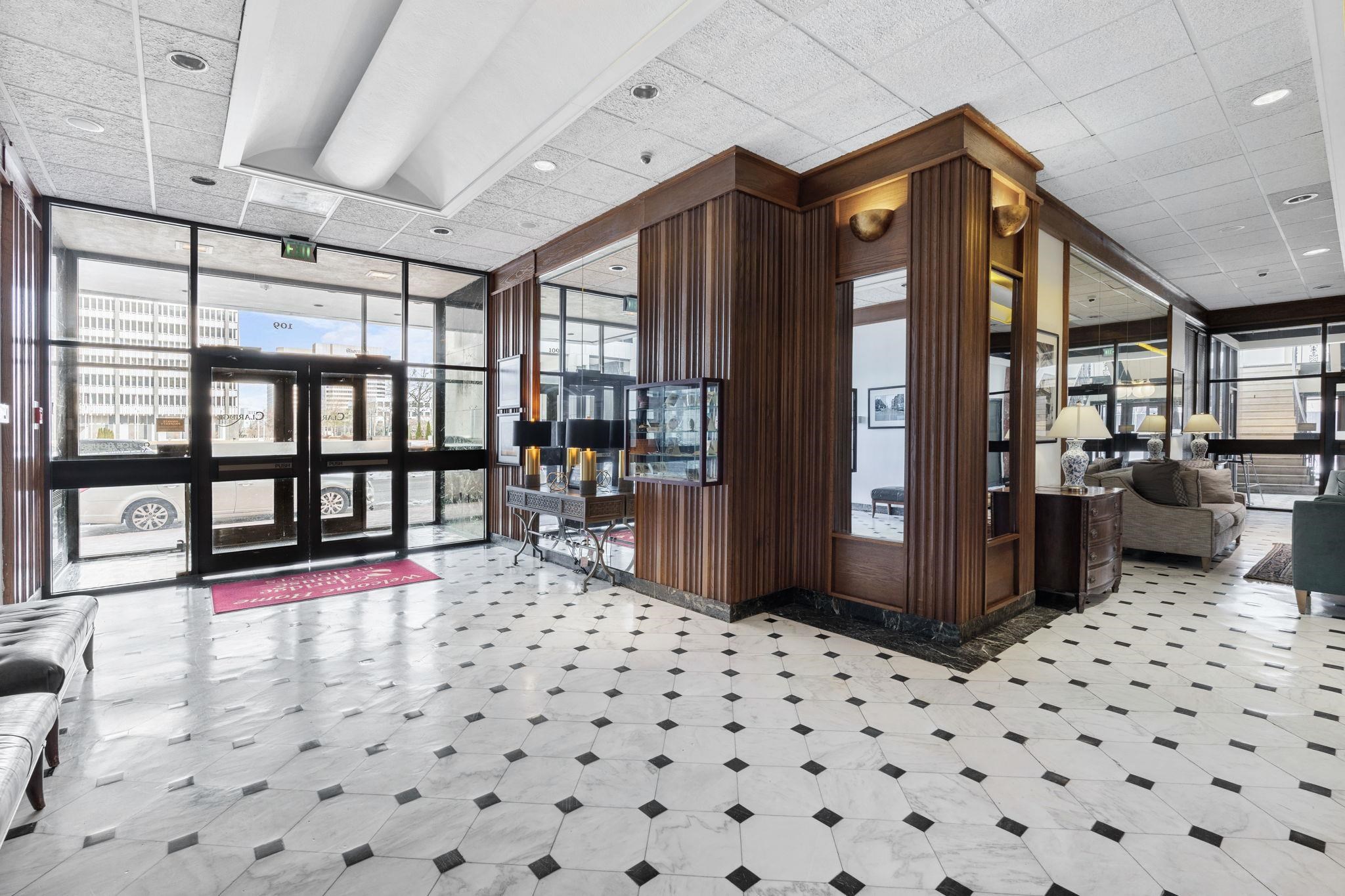 109 North Main Street, Unit 710 Memphis, TN 38103 - Photo 22 of 37 Building lobby featuring expansive windows, a paneled ceiling, recessed lighting, and wood walls