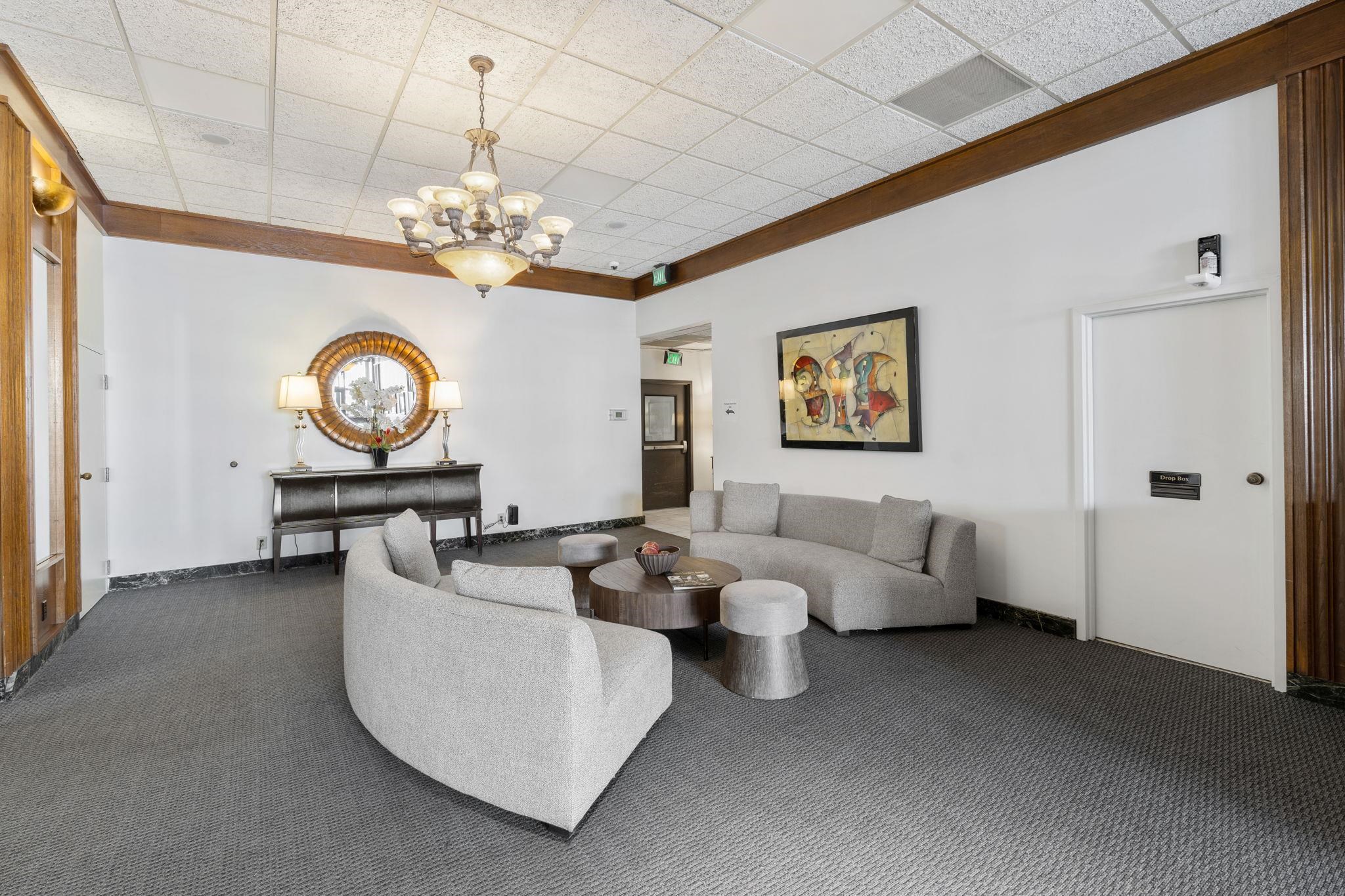 109 North Main Street, Unit 710 Memphis, TN 38103 - Photo 23 of 37 Living area with carpet, hanging lights, and a paneled ceiling