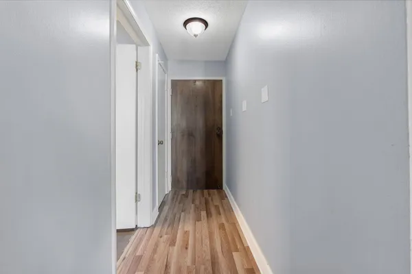 a view of a hallway with wooden floor