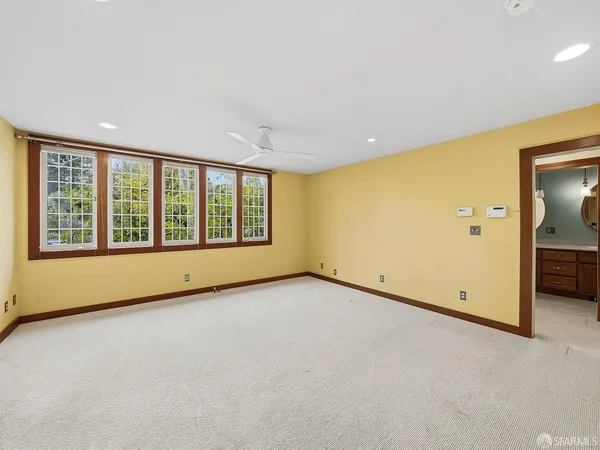 a view of hallway with stairs and wooden floor