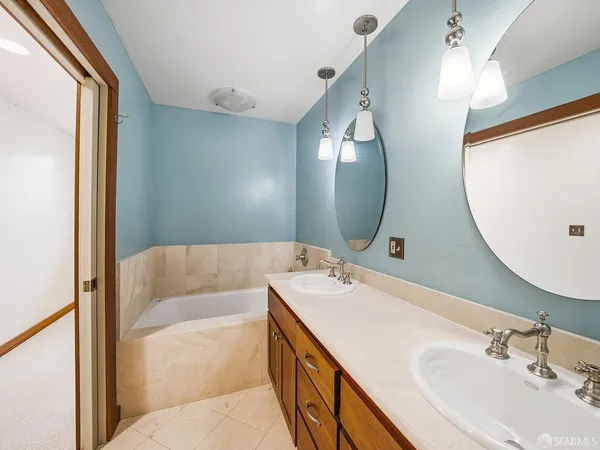 a bathroom with a sink mirror and toilet