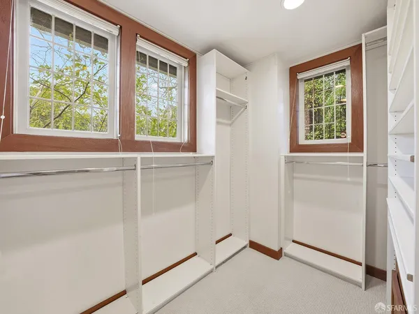 a view of an empty room with stairs and ventilation