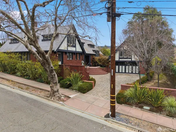 an aerial view of residential houses with outdoor space and parking