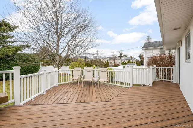 a view of balcony with wooden floor and fence
