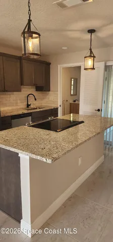 a view of a kitchen counter space and a sink