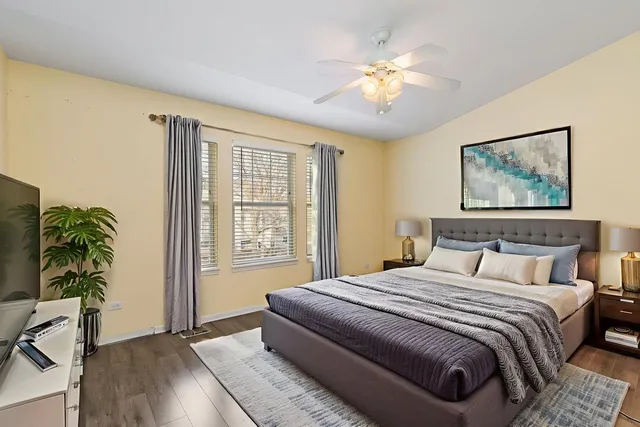 a bedroom with a large bed and a chandelier