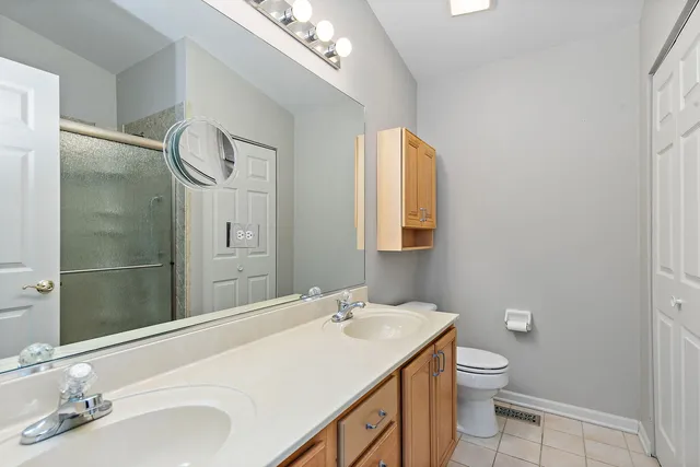 a bathroom with a granite countertop sink a toilet and a mirror