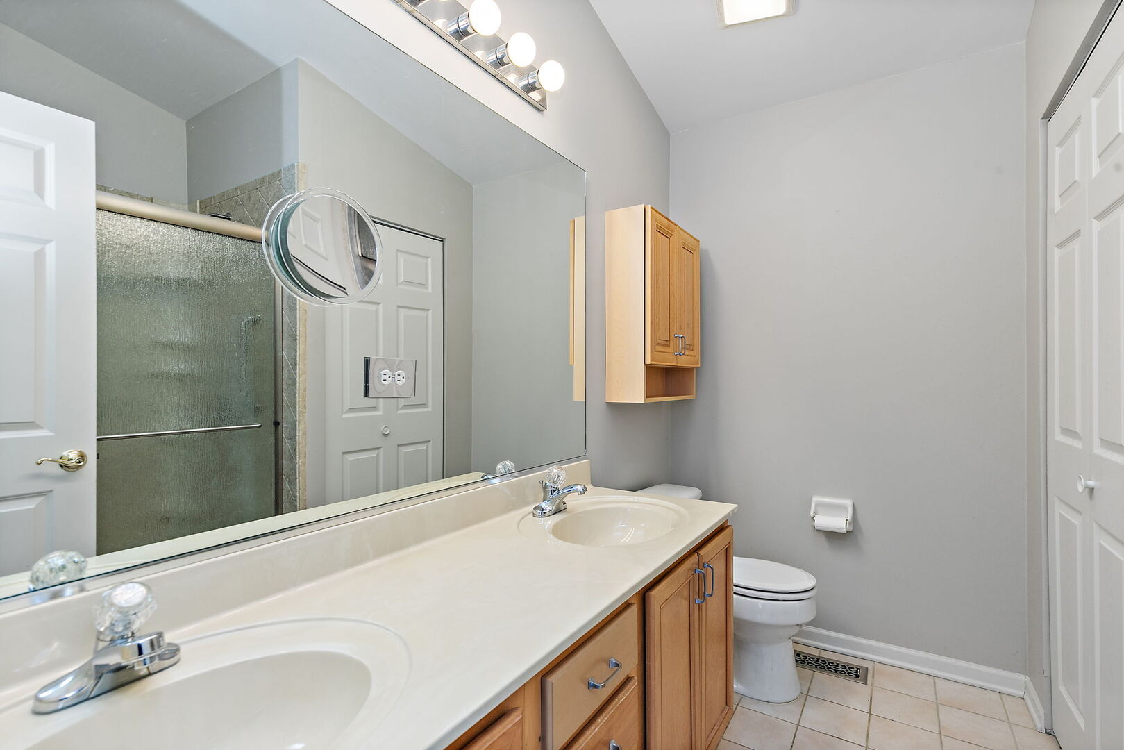 61 Samuel Drive Streamwood, IL 60107 - Photo 18 of 27 a bathroom with a granite countertop sink a toilet and a mirror