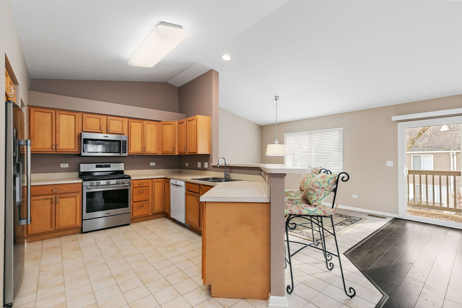 61 Samuel Drive Streamwood, IL 60107 - Photo 7 of 27 a kitchen with a stove a sink and a microwave