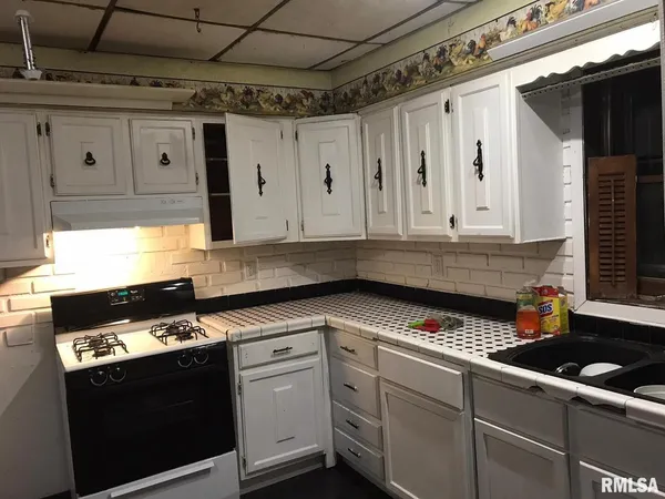 a utility room with a sink a mirror and vanity