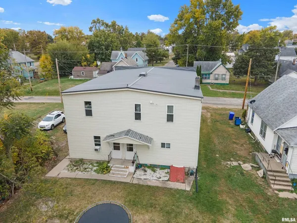 an aerial view of a house with a yard