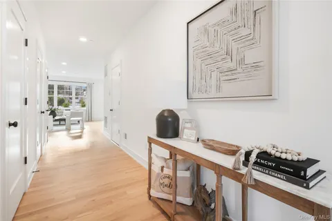 a view of a hallway with workspace and wooden floor