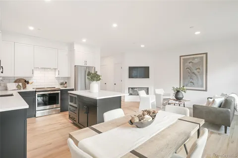 a kitchen with a sink stove and white cabinets