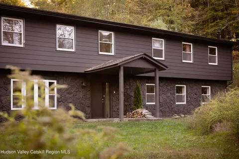 a front view of a house with a yard