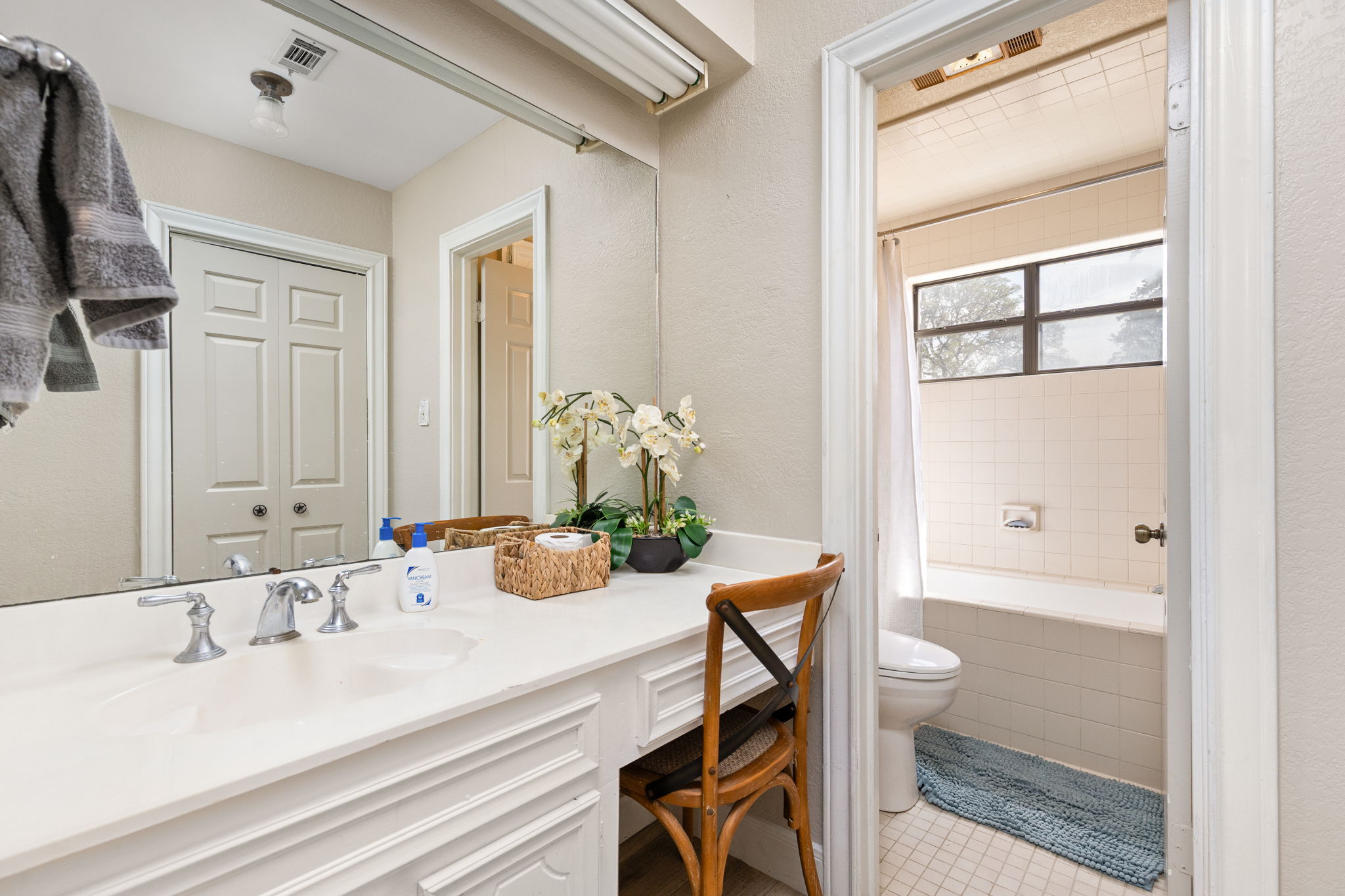 196 Willy Road Bastrop, TX 78602 - Photo 17 of 40 A spacious vanity area connects seamlessly to a private bath with tiled tub enclosure.