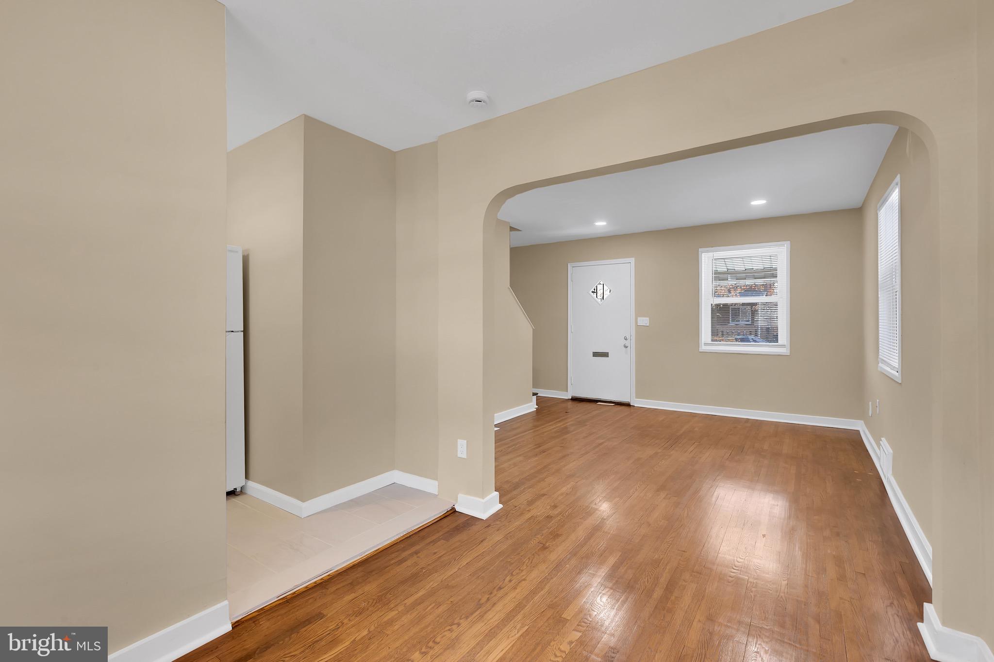 151 Darrington Street Southwest Washington, DC 20032 - Photo 17 of 22 an empty room with wooden floor and windows