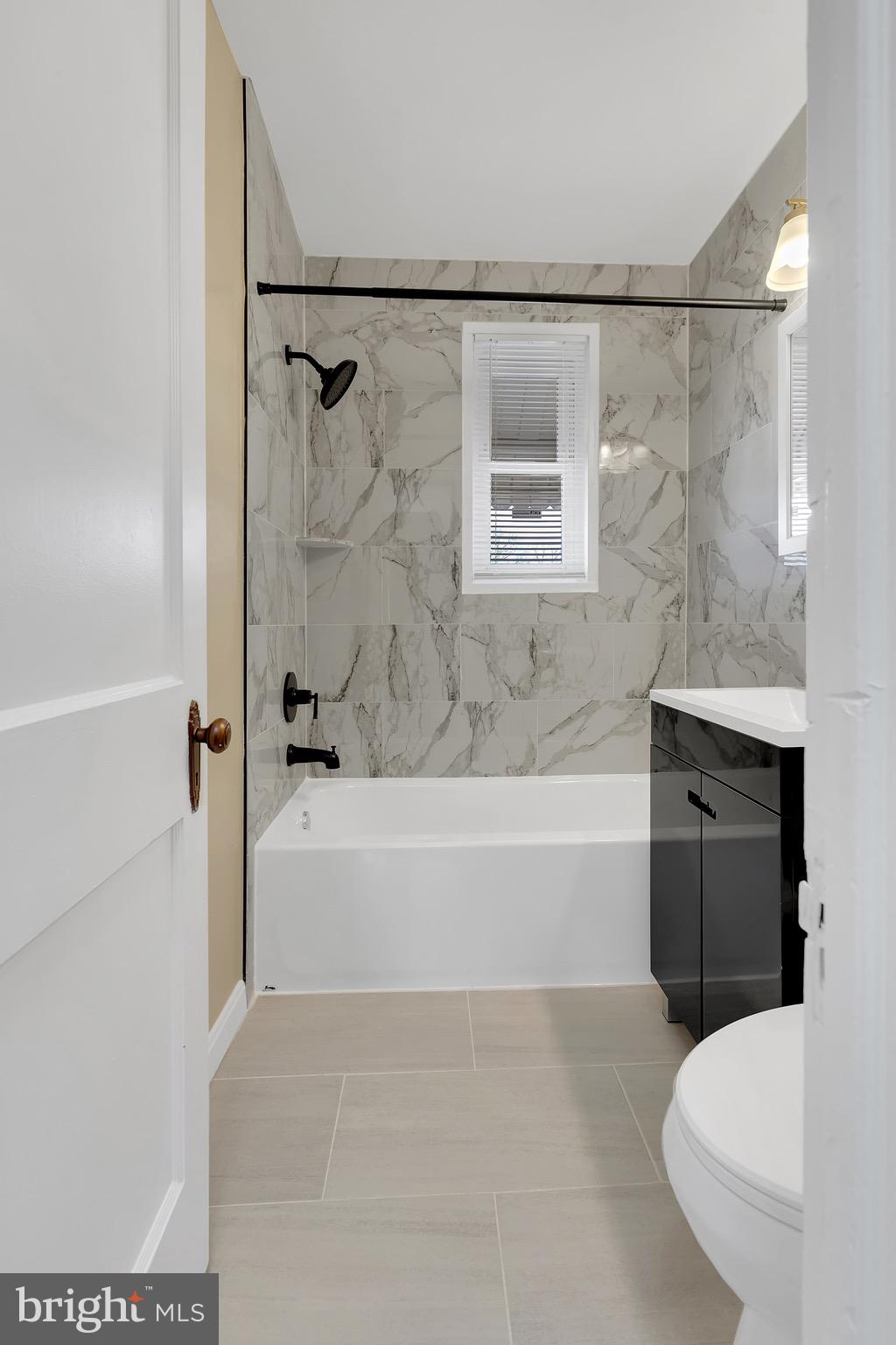 151 Darrington Street Southwest Washington, DC 20032 - Photo 8 of 22 a bathroom with a bathtub and a shower