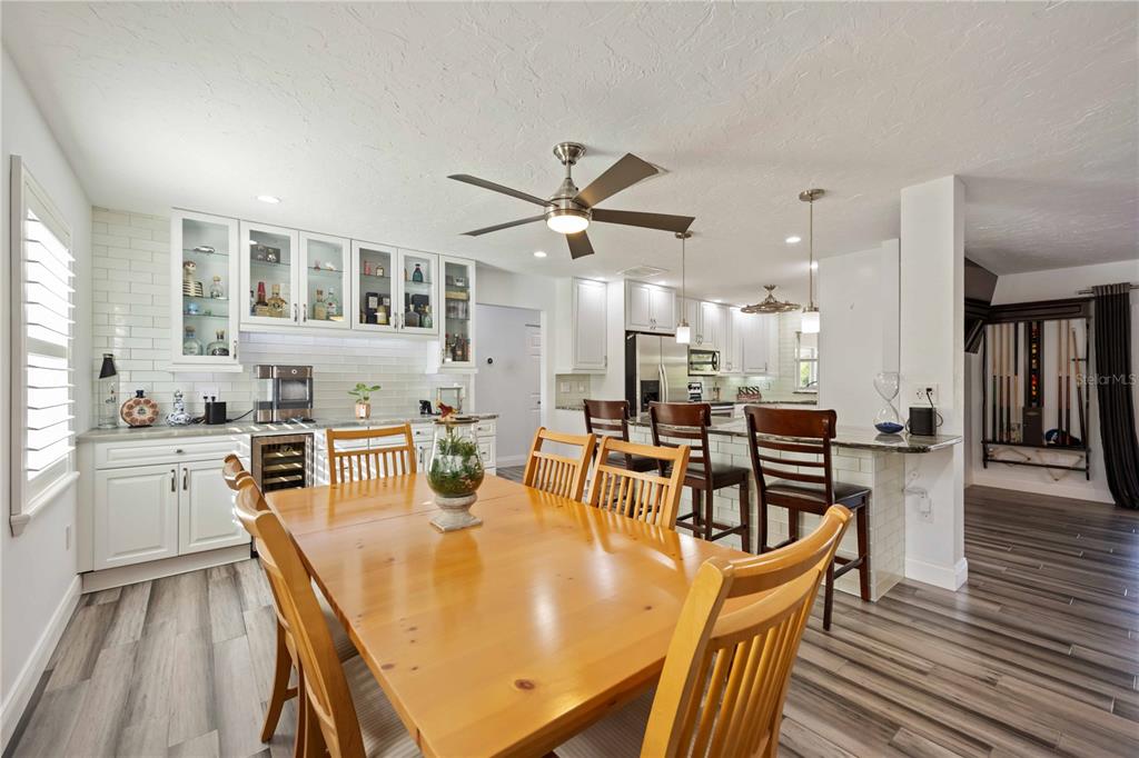 5025 Marsh Field Road Sarasota, FL 34235 - Photo 11 of 69 a dining room with stainless steel appliances a dining table and chairs
