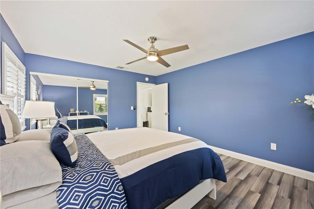 5025 Marsh Field Road Sarasota, FL 34235 - Photo 30 of 69 a bedroom with a bed and a chandelier