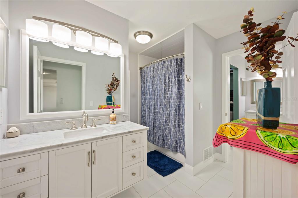 5025 Marsh Field Road Sarasota, FL 34235 - Photo 32 of 69 a bathroom with a sink vanity and a mirror