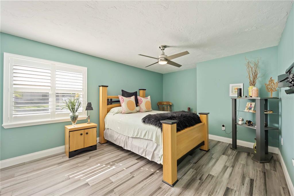 5025 Marsh Field Road Sarasota, FL 34235 - Photo 35 of 69 a bedroom with a bed and a chandelier