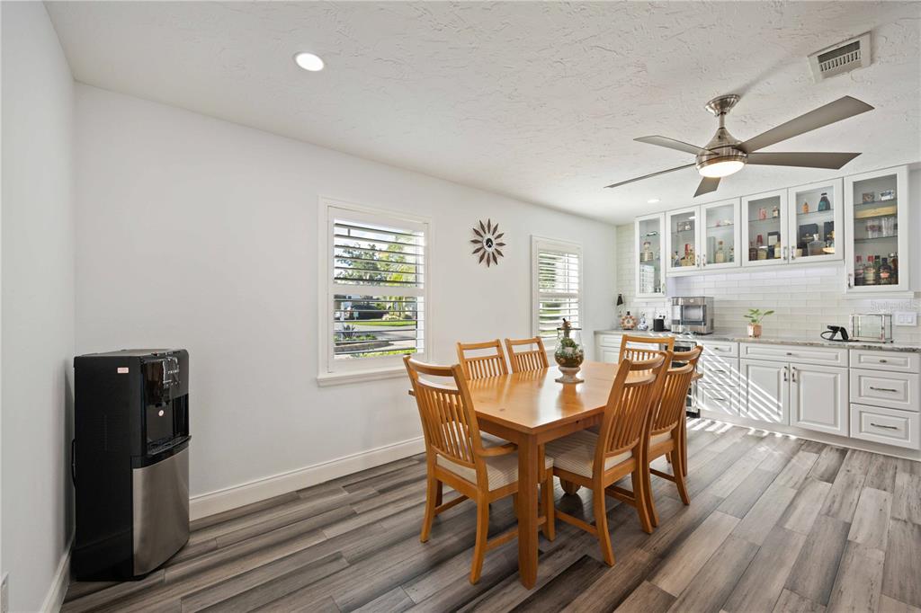 5025 Marsh Field Road Sarasota, FL 34235 - Photo 10 of 69 a view of a dining room with furniture and wooden floor