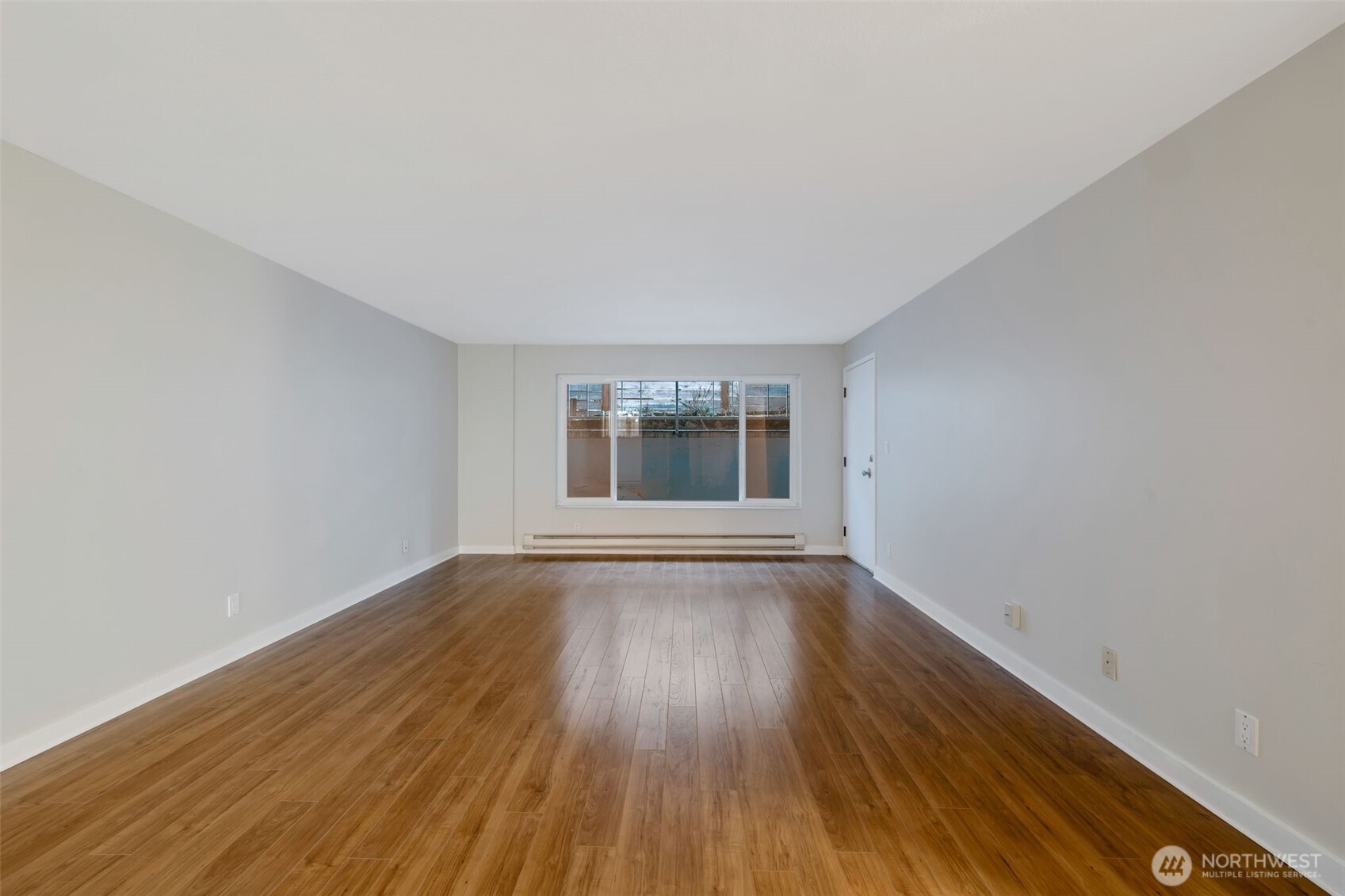4324 Phinney Avenue North, Unit 1 Seattle, WA 98103 - Photo 12 of 20 a view of an empty room with wooden floor and window
