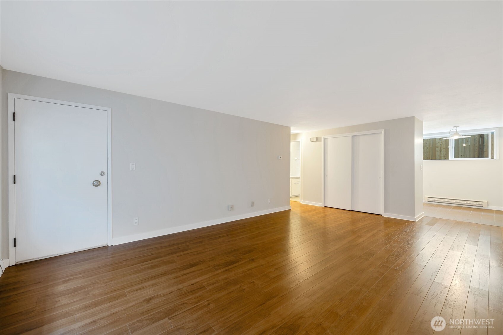 4324 Phinney Avenue North, Unit 1 Seattle, WA 98103 - Photo 17 of 20 a view of an empty room with wooden floor and a window