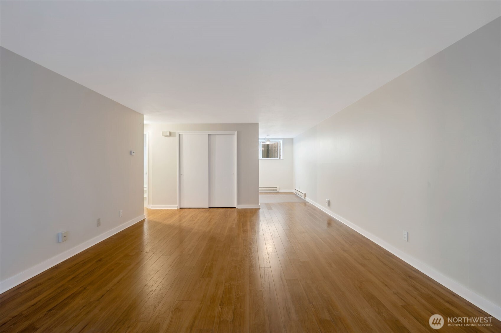 4324 Phinney Avenue North, Unit 1 Seattle, WA 98103 - Photo 18 of 20 a view of an empty room and wooden floor