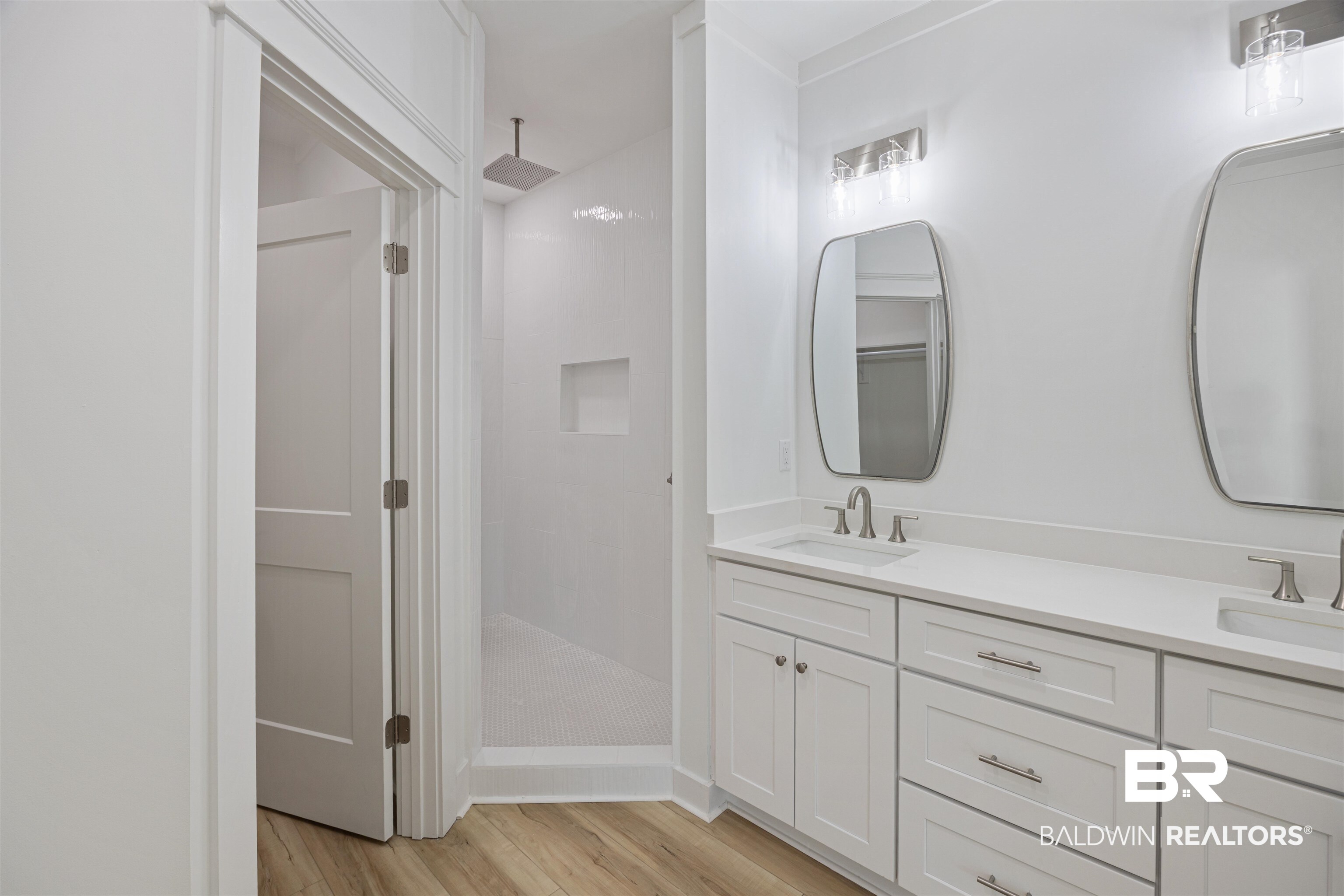 27591 Canal Road Orange Beach, AL 36561 - Photo 25 of 51 Full bathroom featuring light wood-style flooring, a stall shower, and double vanity
