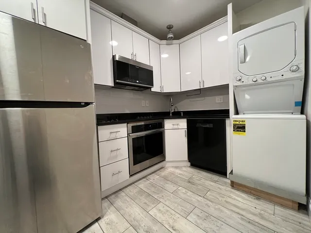 a kitchen with a refrigerator stove and microwave
