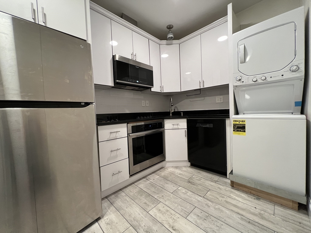 69 Appleton Street, Unit 22 Quincy, MA 02171 - Photo 2 of 8 a kitchen with a refrigerator stove and microwave