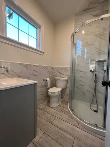 a bathroom with a sink toilet and shower