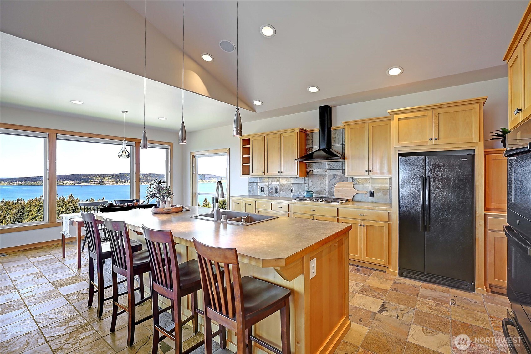 1081 Morgan Way Camano Island, WA 98282 - Photo 15 of 39 a kitchen with stainless steel appliances granite countertop table chairs refrigerator and microwave