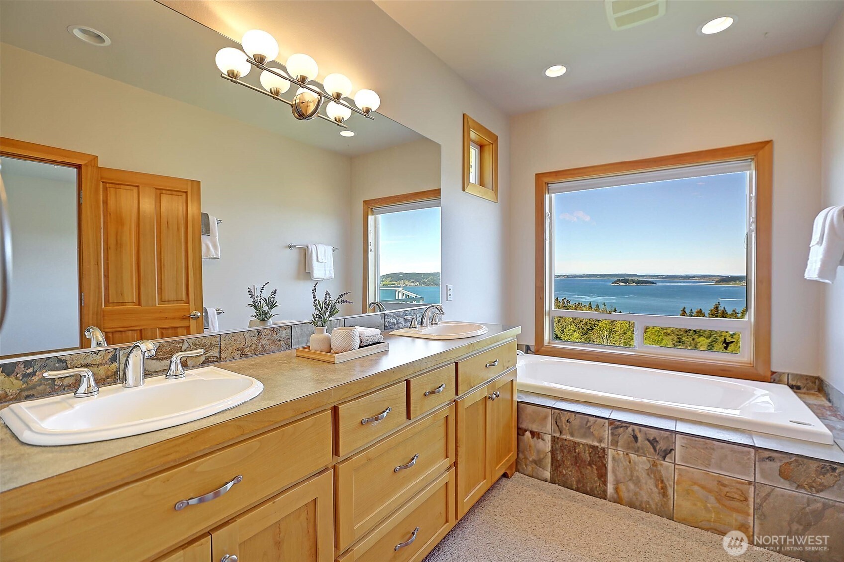 1081 Morgan Way Camano Island, WA 98282 - Photo 20 of 39 a spacious bathroom with a double vanity sink and a large mirror
