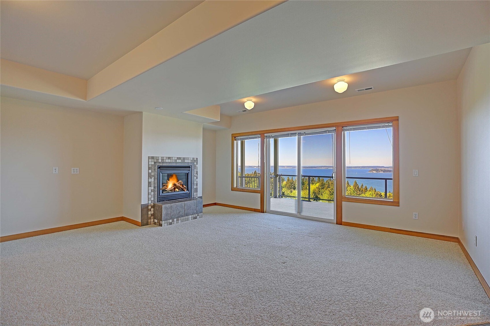 1081 Morgan Way Camano Island, WA 98282 - Photo 28 of 39 a view of an empty room with a fireplace and a window