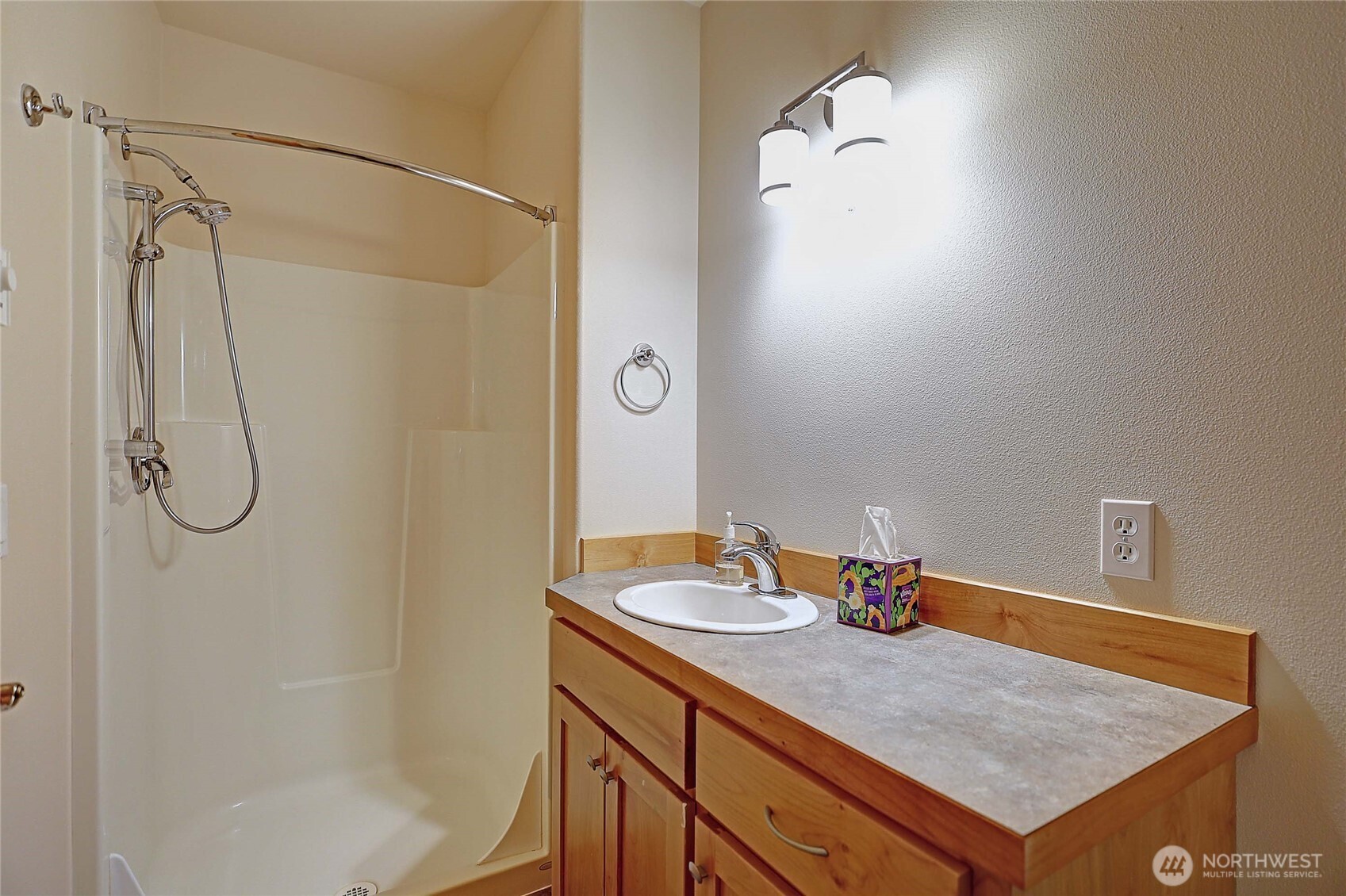 1081 Morgan Way Camano Island, WA 98282 - Photo 30 of 39 a bathroom with a granite countertop sink a shower and a mirror