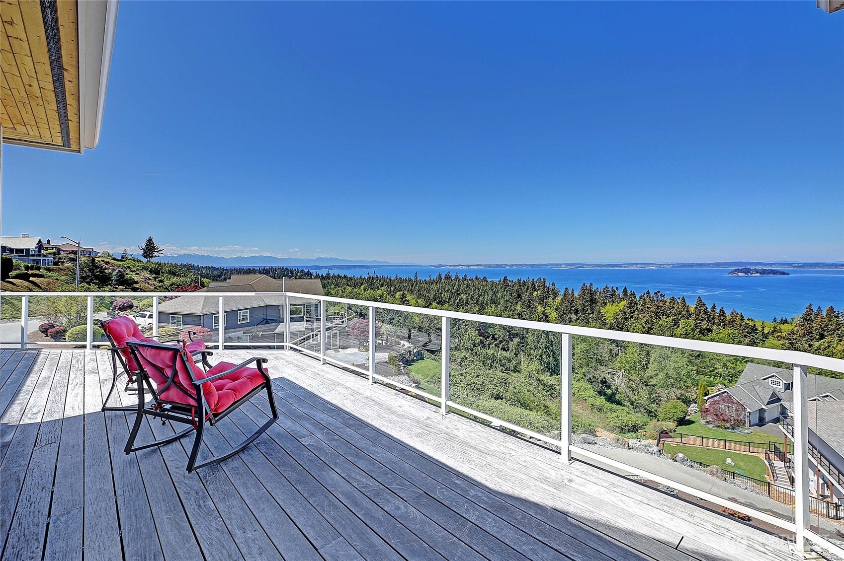 1081 Morgan Way Camano Island, WA 98282 - Photo 34 of 39 a view of a balcony with chairs and wooden floor